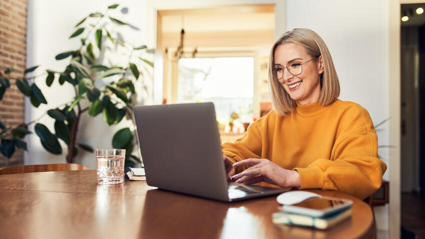 Woman working on a laptop at a table